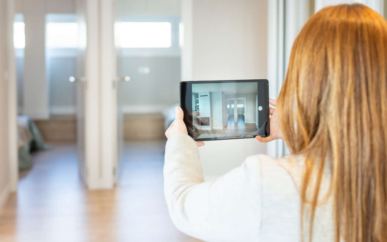 SEO for estate agents - woman taking a home for sale photo