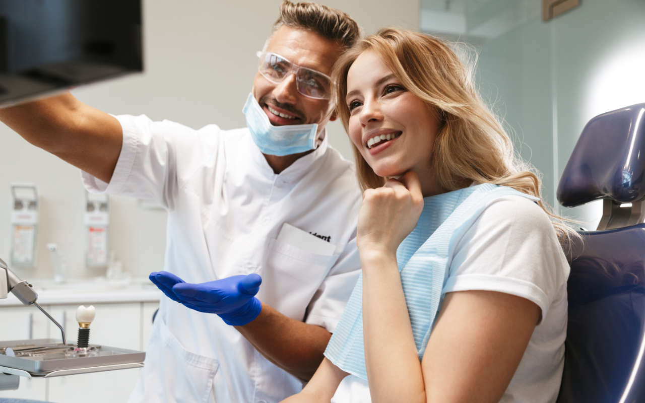 Happy patient looking at an x-ray of their healthy teeth
