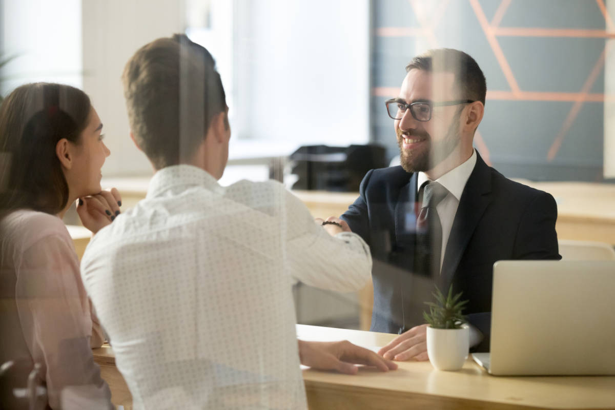 Customers in a bank branch agreeing a mortgage deal