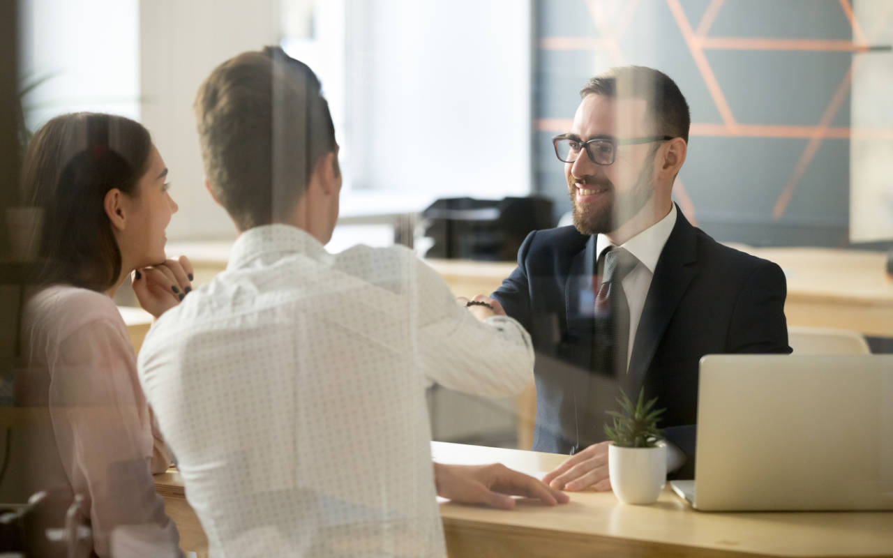 Customers in a bank branch agreeing a mortgage deal