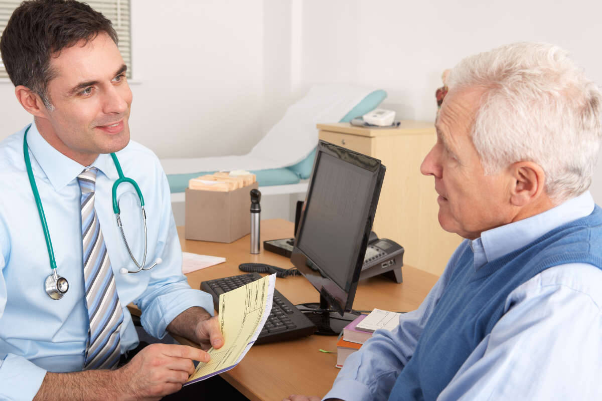 Doctor talks to a patient at a GP surgery