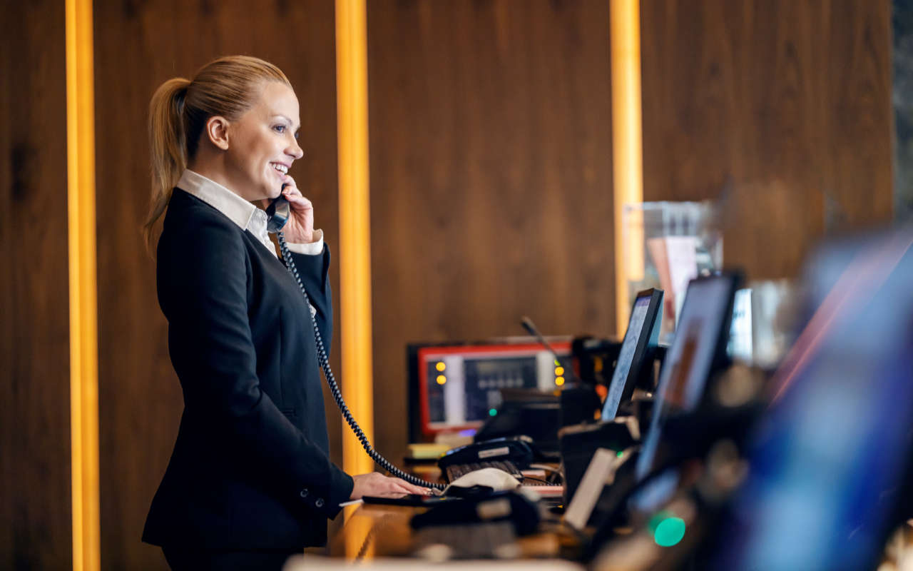 Hotel staff talking on phone to guest