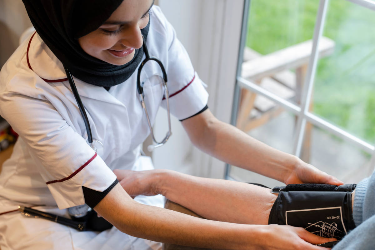 Medical professional taking blood pressure from a patient