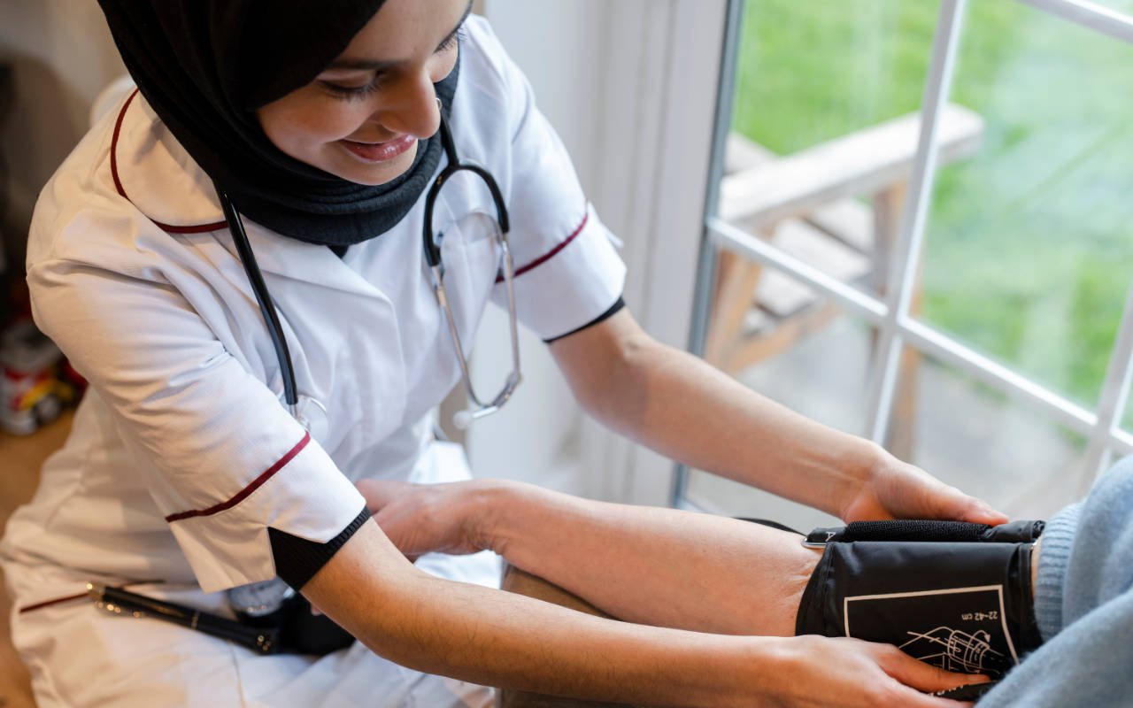 Medical professional taking blood pressure from a patient